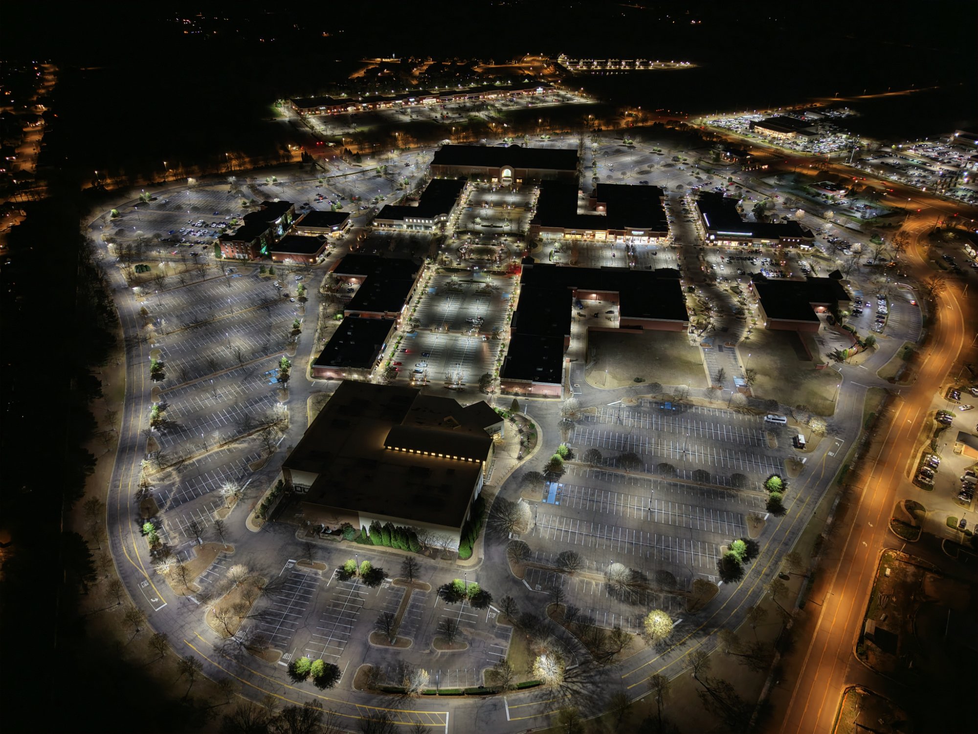Aerial view of same shopping center after eneroi LED retrofit - uniform white light across entire property