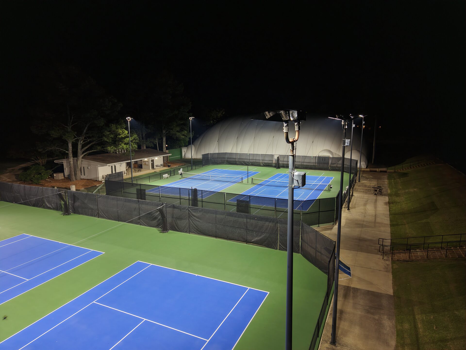 Close-up view of sport-grade LED fixtures installed on pole at Windyke Country Club tennis courts